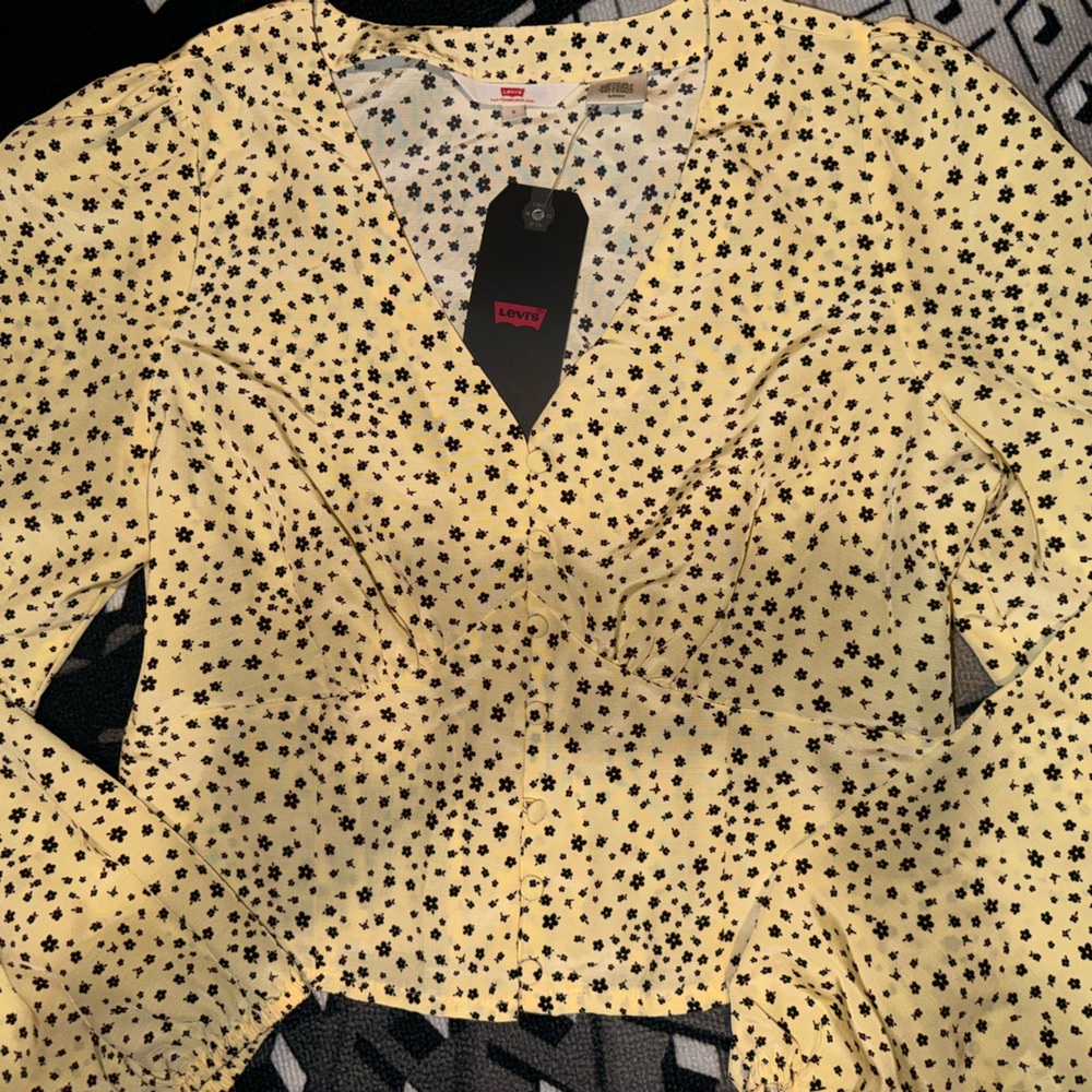 Levi top for women or teens. Yellow in color w/ black flowers.